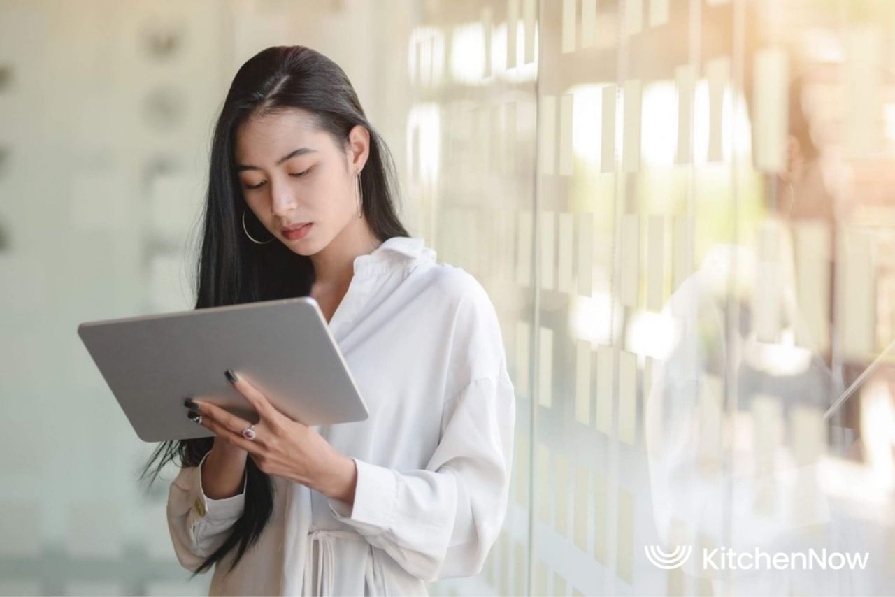 asian-girl-managing-cloud-kitchen-with-tablet