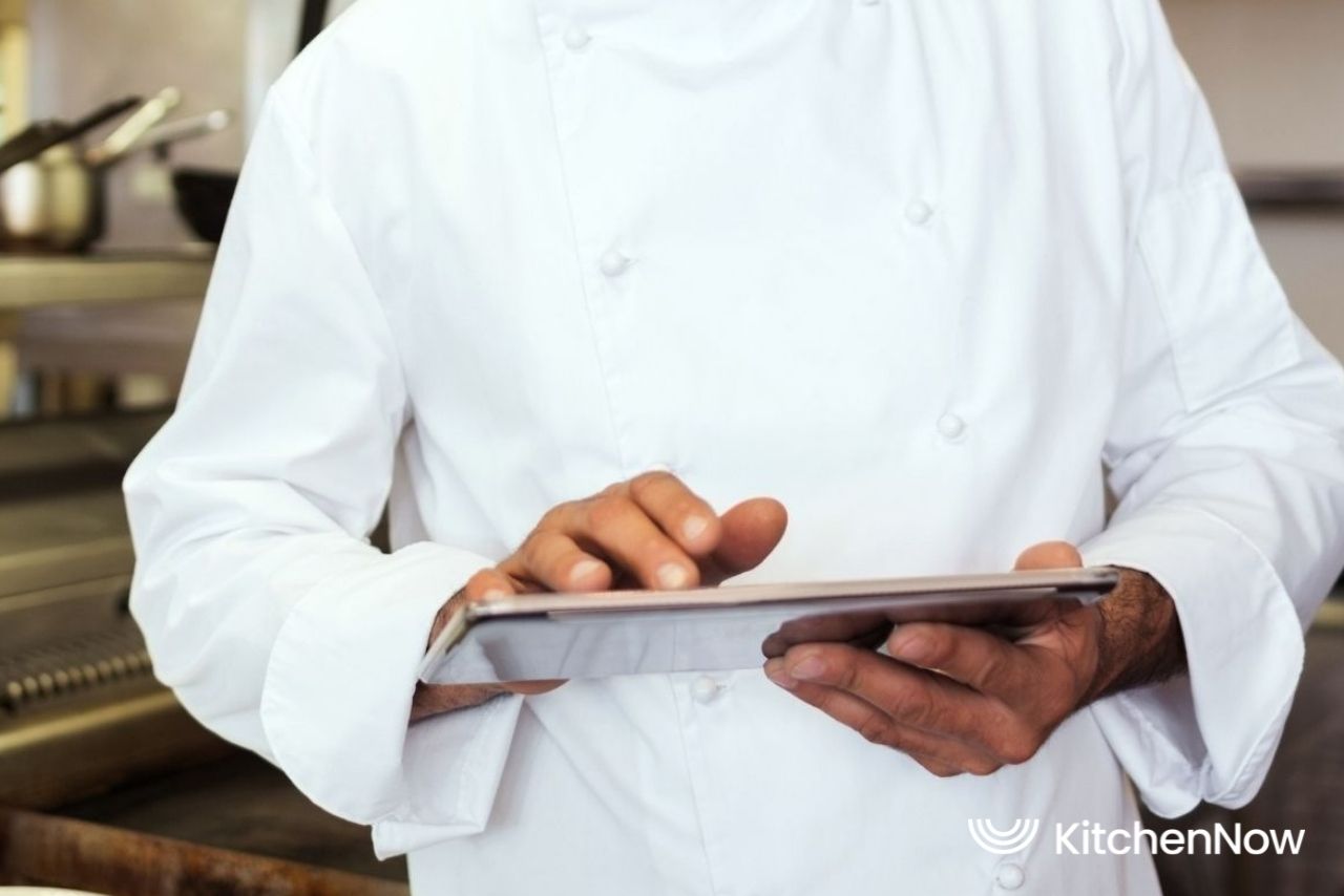 chef-monitoring-cloud-kitchen-with-a-tablet